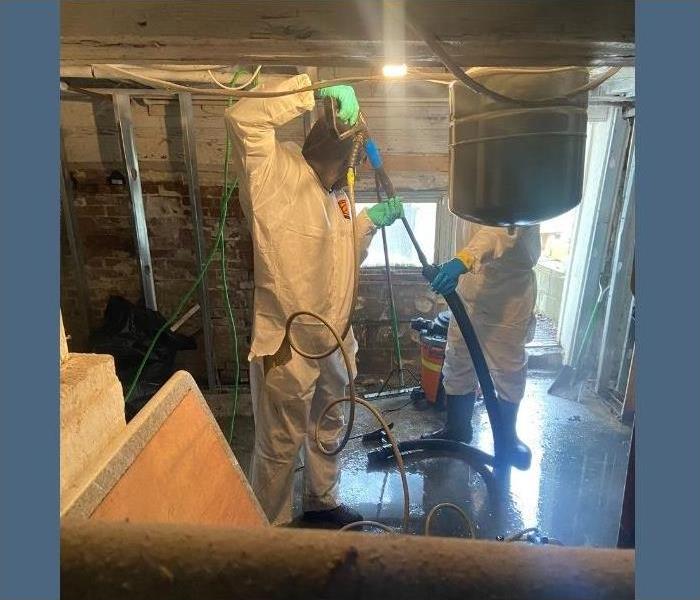 Our SERVPRO technicians in hazmat suits removing sewage from a Saratoga basement.