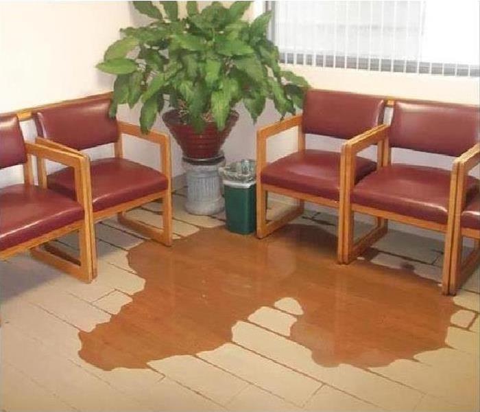 An office waiting room with water on the floor.