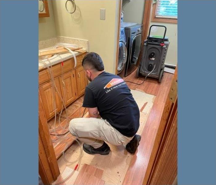 A SERVPRO professional pulling up the floors that were affected by water damage.