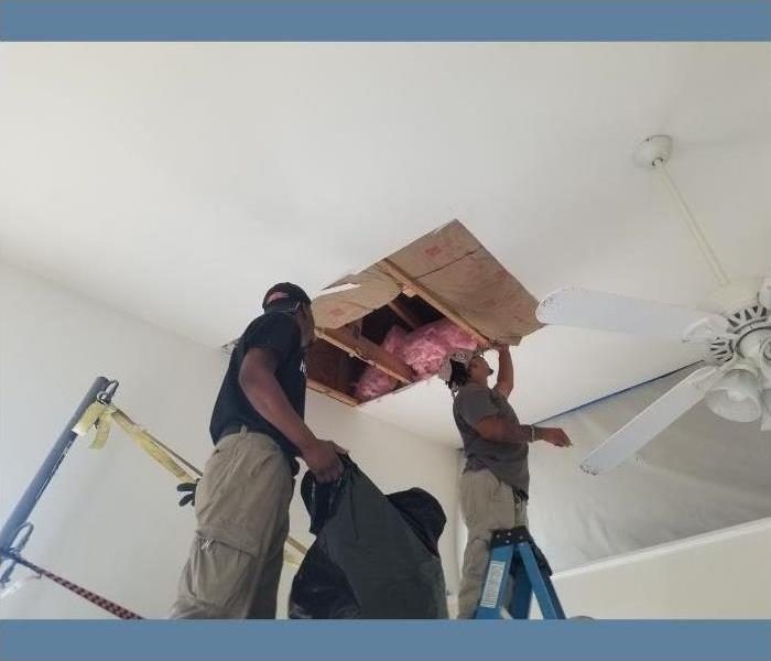 Our certified SERVPRO technicians fixing water damage in the ceiling.
