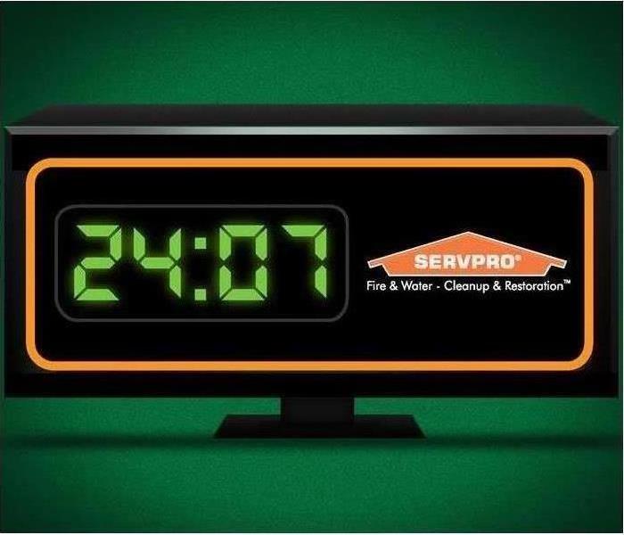 An alarm clock that reads 24:07 with the SERVPRO logo.