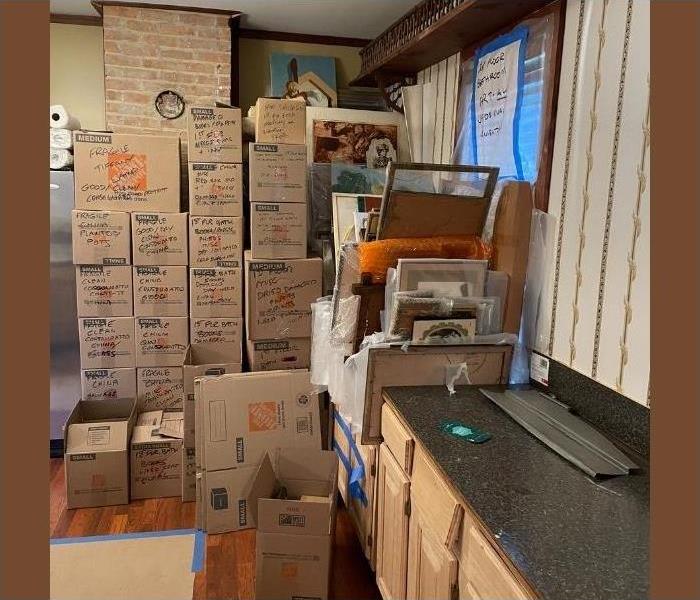 A kitchen in Saratoga with stacks of boxes piled preparing for move out after a water damage emergency.