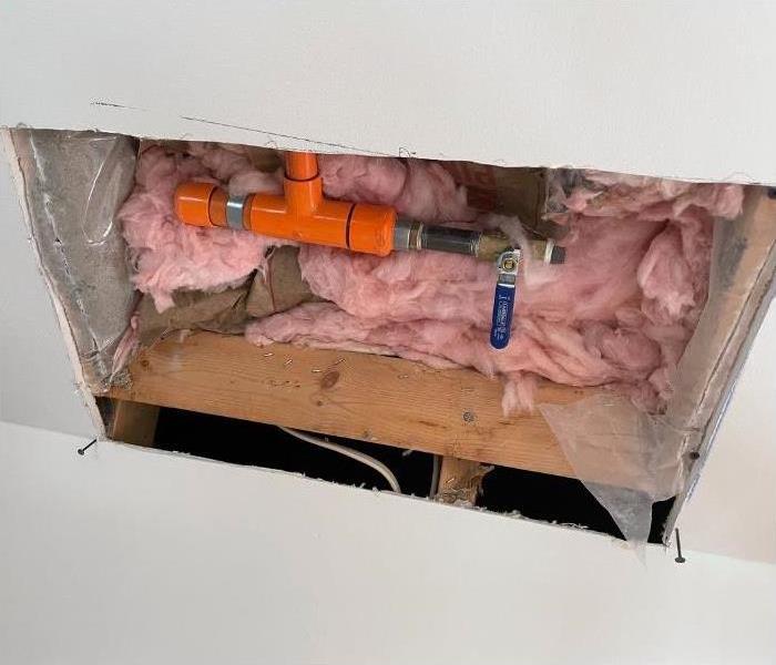 A hole cut into the ceiling of a Saratoga Springs home exposing wet insulation.